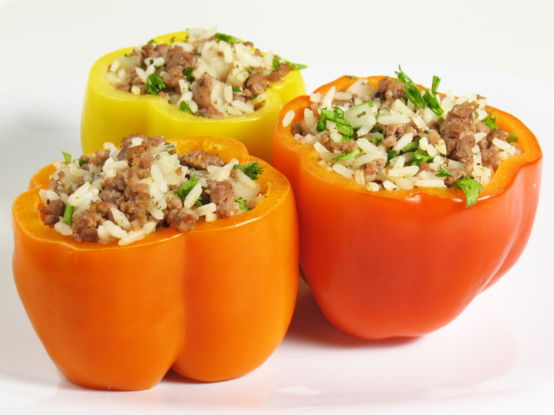 Colorful stuffed peppers with mince, herbs and rice