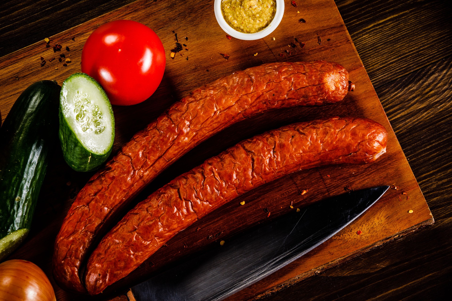 smoked sausages on cutting board